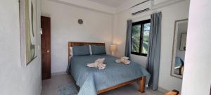 a bedroom with a bed with two towels on it at Lickety Split 2 - Northside, Oceanview Retreat in Caye Caulker