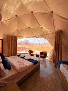 a bedroom with a bed in a tent at Ayla Rum Luxury Camp in Wadi Rum