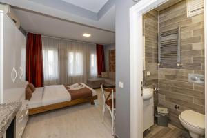 a bedroom with a bed and a bathroom at Lion Apart Hotel Taksim in Istanbul +47 photos