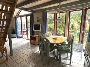 a dining room with a wooden table and chairs at exklusives skandinavisches Ferienhaus in Granzow