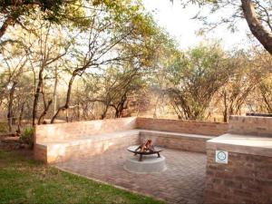a fire pit in the middle of a park at Nzenga Lodge in Hoedspruit