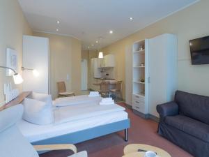 a living room with a couch and a table at Elegant eingerichtete Ferienwohnung in Granzow +24 photos