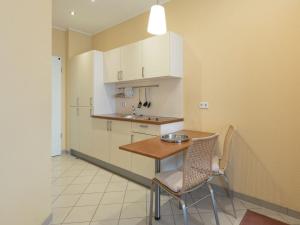 a small kitchen with a table and two chairs at Elegant eingerichtete Ferienwohnung in Granzow
