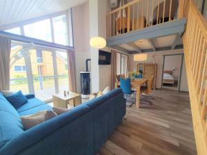 een woonkamer met een blauwe bank en een tafel bij exklusives skandinavisches Ferienhaus in Granzow