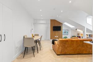 a living room with a couch and a table at Luxury modern 1 bed between Hampstead and Camden in London