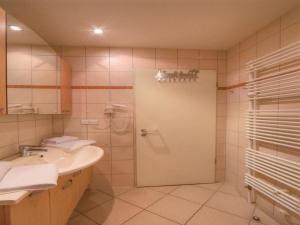 a bathroom with a shower and a sink and a door at Elegant eingerichtete Ferienwohnung in Granzow +21 photos