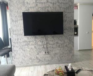 a living room with a flat screen tv on a wall at Apartament Zen Home in Craiova