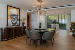 a kitchen and dining room with a painting of a chef at Luxury Apartment at Savoy Monumentalis by An Island Apart in Funchal
