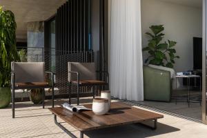 a room with two chairs and a wooden table at Luxury Apartment at Savoy Monumentalis by An Island Apart in Funchal