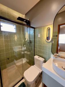 a bathroom with a toilet and a shower and a sink at Ap Da Ilha in Alter do Chao