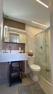 a bathroom with a toilet and a sink and a shower at Boutique House - Ilha Grande in Abraão +12 photos