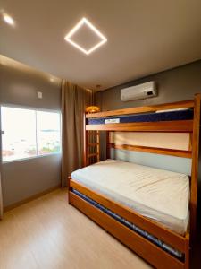 a bedroom with two bunk beds and a window at Ap Da Ilha in Alter do Chao