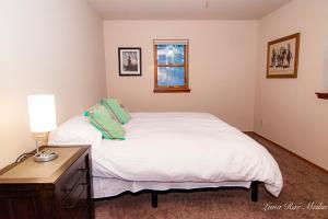 a bedroom with a bed and a table with a lamp at Durango Colorado Four Bedroom Two Bathroom Home in Durango