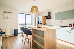 a kitchen with a island with a counter top at Duplex d Exception Vue sur le port de Quiberon in Quiberon