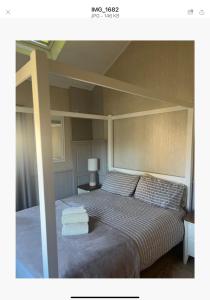 a bedroom with a bed with two towels on it at The Annex Apartment is on Cheddar Bridge Apartments in Cheddar