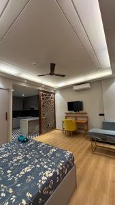 a bedroom with a bed and a living room at Galaxy blue sapphire plaza in Ghaziabad +28 photos