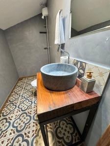 a bathroom with a large bowl sink on a wooden table at Pousada Memórias de Minas in Ouro Preto +78 photos