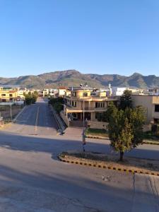 an empty street in a small town with buildings at Mountain Villa Family Guest House in Islamabad
