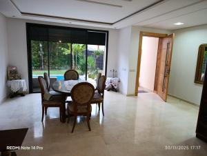 a dining room with a table and chairs at Océane palm in Casablanca