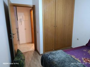 a bedroom with a bed and a wooden cabinet at Océane palm in Casablanca +21 photos