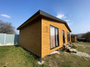 a tiny house sitting on top of a field at Tianeti Apple Cottages 