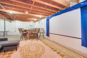 a room with a table and chairs and a large screen at 4 Mi to Bromley Mtn Family-Friendly Retreat! in Landgrove Town Center