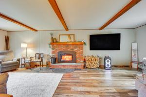 a living room with a fireplace and a flat screen tv at 4 Mi to Bromley Mtn Family-Friendly Retreat! in Landgrove Town Center