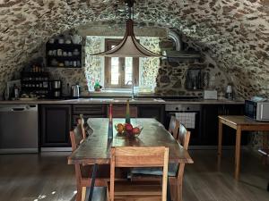 a kitchen with a wooden table in a room at Kleopatra House in Leonidio