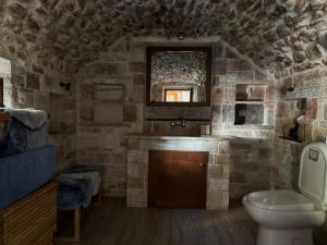 a stone bathroom with a sink and a toilet at Kleopatra House in Leonidio +34 photos