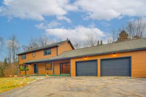 a house with two garage doors in a driveway at 4 Mi to Bromley Mtn Family-Friendly Retreat! in Landgrove Town Center
