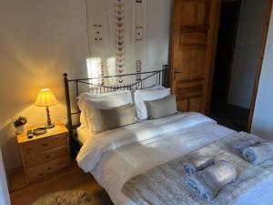 a bedroom with a large bed with white sheets and pillows at Evergreen Elati in Elati Trikalon