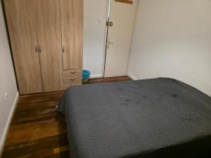 a bedroom with a bed and a wooden floor at Habitación zabalburu D&S in Bilbao