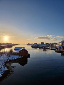 a house on a dock in a body of water at Downtown apartment in Svolvær in Svolvær