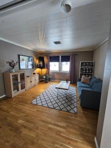 a living room with a couch and a table at Downtown apartment in Svolvær in Svolvær