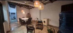 a living room with a table and chairs and lights at Habitación en casa rústica con aire acondicionado y wifi en el centro de Asunción in Asuncion +4 photos