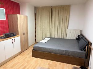 a small bedroom with a bed and a sink at Novo in Prague