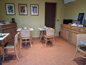 a restaurant with two tables and chairs and a counter at Casaromatica in Pigna