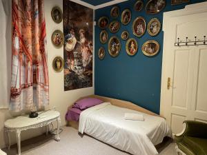 a bedroom with a bed and plates on the wall at Social Guest House in Sofia +23 photos