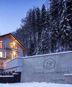 a building in the snow with a sign in front of it at Jasmínový Ráj in Vítkovice