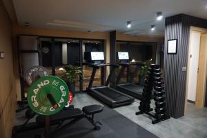 a gym with several treadmills and a sign in a room at Oaza Szczęścia in Koniaków