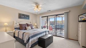 a bedroom with a bed and a sliding glass door at Easy Breezy - Lakefront for 6 in Sunrise Beach