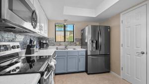 a kitchen with a refrigerator and a sink at Easy Breezy - Lakefront for 6 in Sunrise Beach +22 photos
