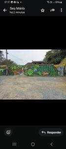 a picture of a wall with graffiti on it at Hostel pousada floresta in Joinville