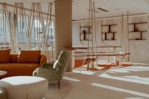 a living room with a couch and a table at Hotel Reva TAHITI in Papeete
