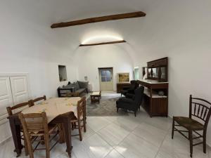 a living room with a table and chairs and a couch at Alexander House 1 in Leonidio