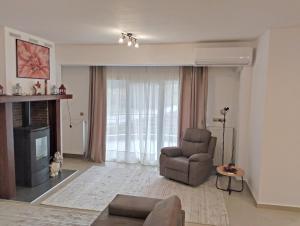 a living room with a chair and a fireplace at Chloe Maxi Apt 108 sqm in Kastoria +42 photos