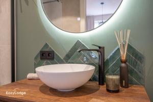 a bathroom with a bowl sink and a mirror at FORTESSE - Luxury apartment near the sea with parking in Ostend