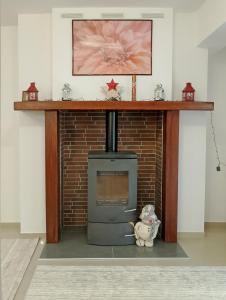 a brick fireplace with a stove in a room at Chloe Maxi Apt 108 sqm in Kastoria