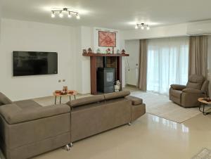 a living room with a couch and a fireplace at Chloe Maxi Apt 108 sqm in Kastoria