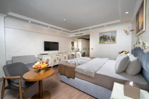 a hotel room with a large bed and a television at Almadina Hotel Istanbul in Istanbul